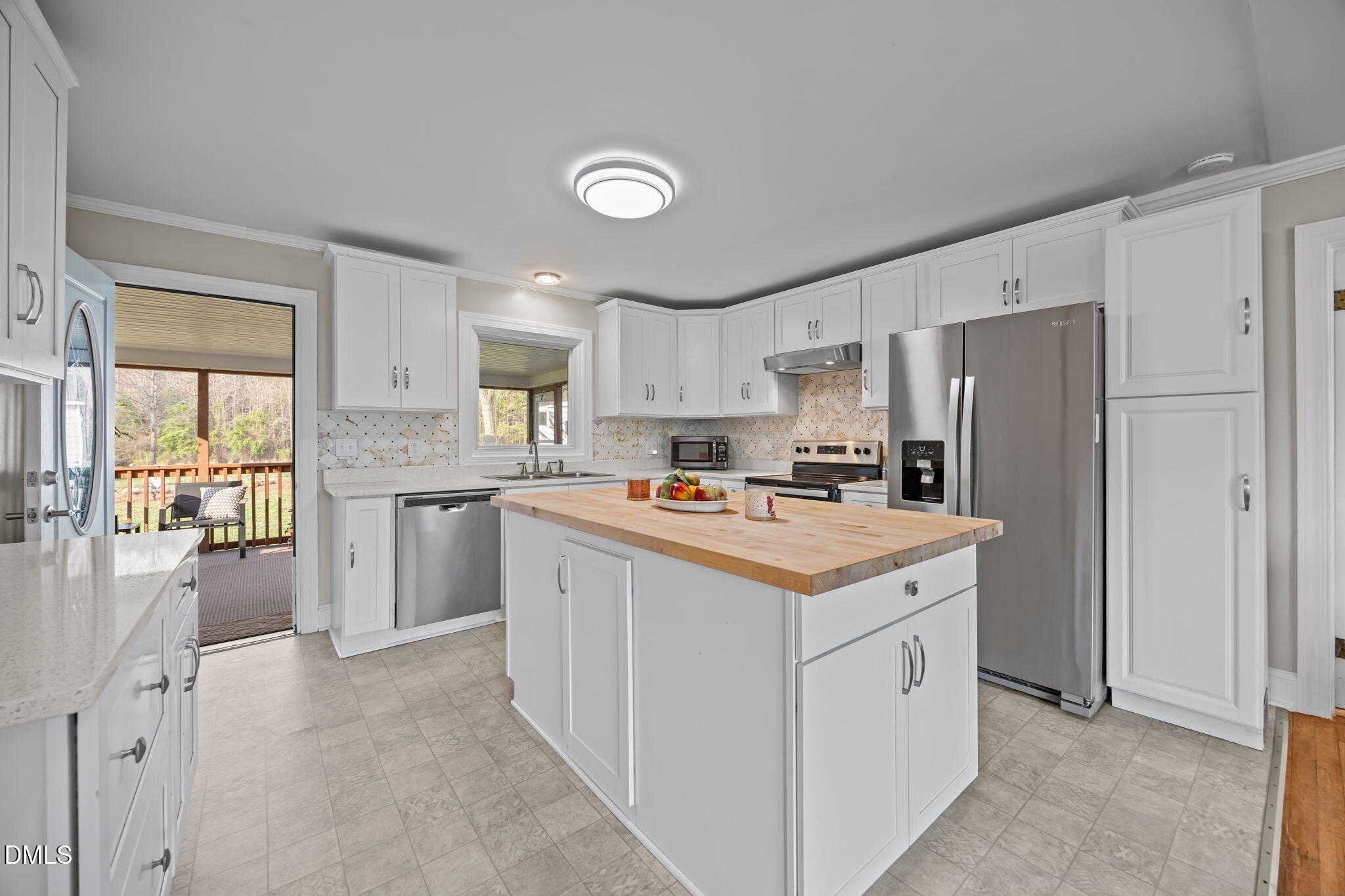 10612 Durham Road Timberlake, NC 27583 - Photo 10 of 42 a kitchen that has a lot of white cabinets and stainless steel appliances