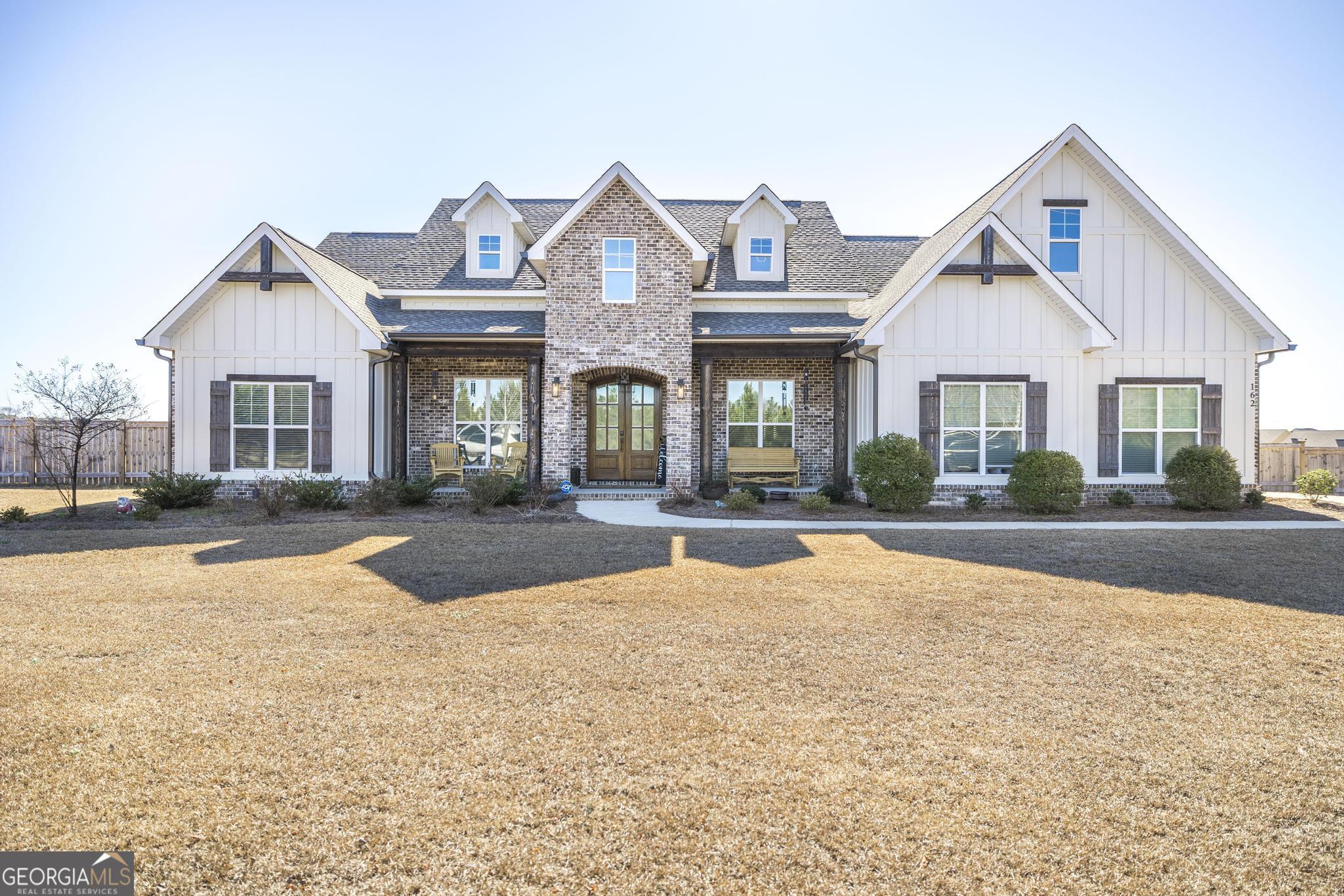 a front view of a house with yard patio and glass door