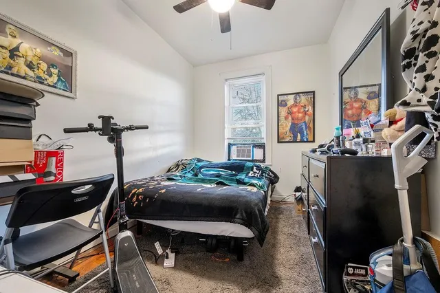 a bedroom with furniture and a window
