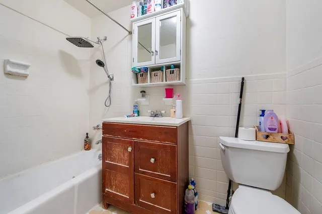 a bathroom with a sink vanity mirror and toilet