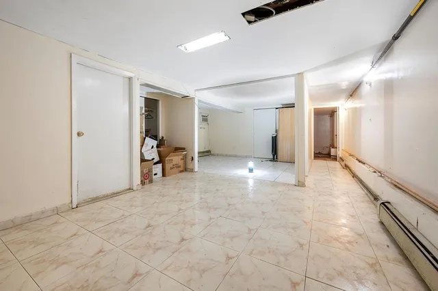 a view of a hallway with furniture and a ceiling fan
