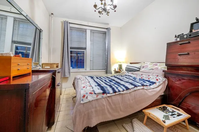 a bedroom with bed and window