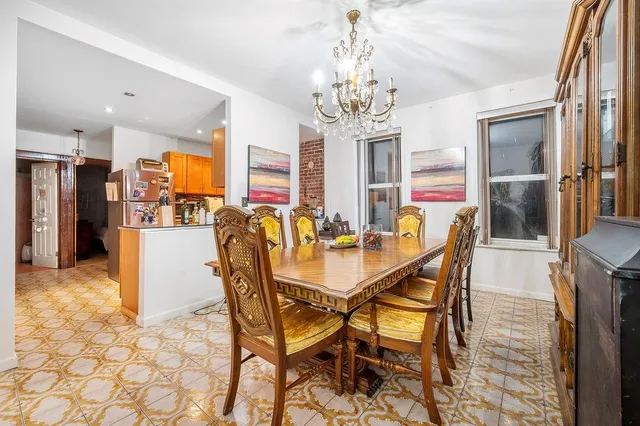 a view of a dining room with furniture and a chandelier