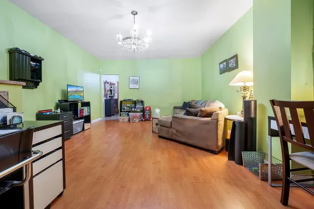 a living room with furniture and a chandelier