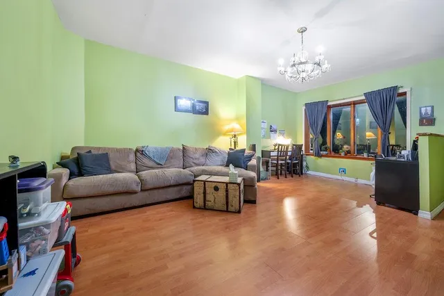 a living room with furniture and a chandelier