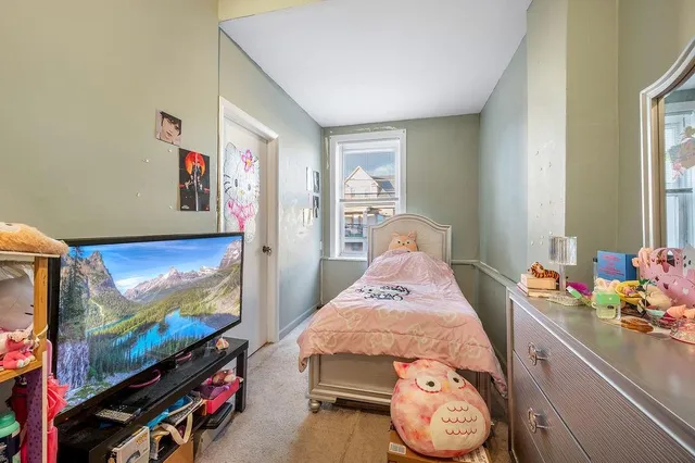 a bedroom with furniture and a flat screen tv