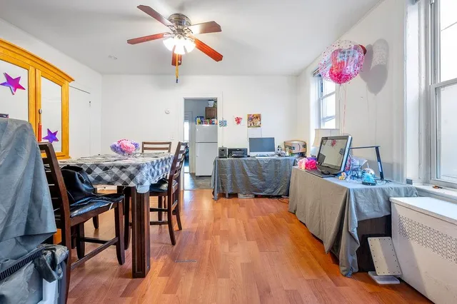 a living room with dining room and wooden floor