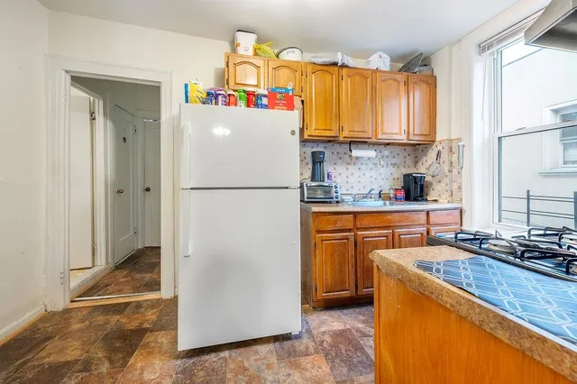 a white refrigerator freezer sitting in a kitchen