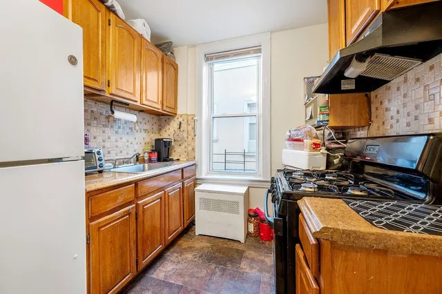 a kitchen with stainless steel appliances granite countertop a stove and a sink