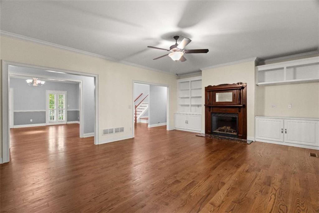 2058 Sewanee Court Villa Rica, GA 30180 - Photo 11 of 81 a view of an empty room with wooden floor and a fireplace