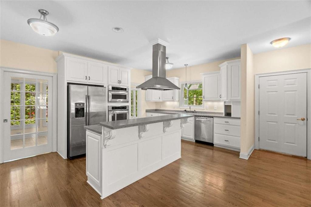 2058 Sewanee Court Villa Rica, GA 30180 - Photo 12 of 81 a kitchen with white cabinets and stainless steel appliances