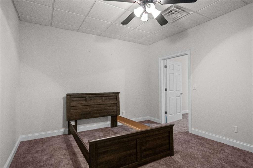 2058 Sewanee Court Villa Rica, GA 30180 - Photo 50 of 81 a room with furniture and a chandelier