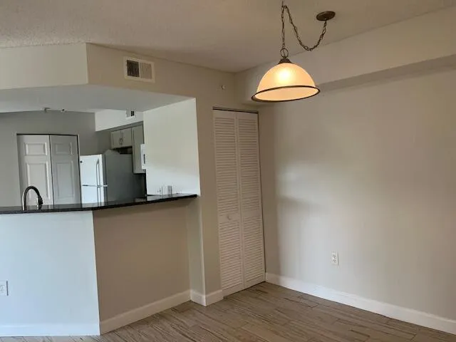 a room with wooden floor and white walls