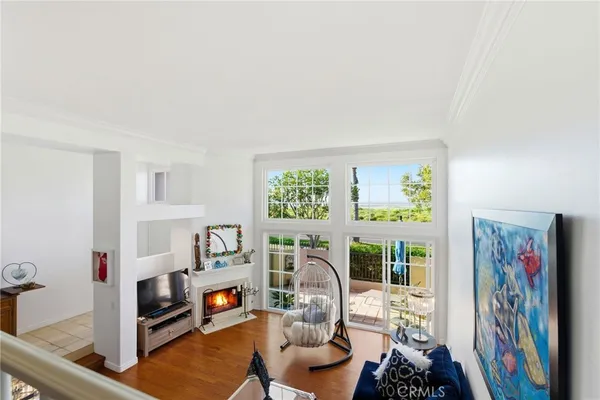 a living room with furniture a fireplace and a large window