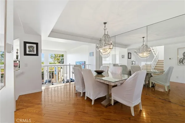 a view of a dining room with furniture wooden floor and chandelier