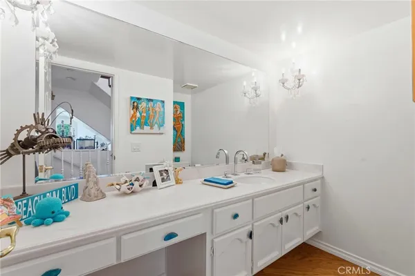 a bathroom with a double vanity sink and a mirror