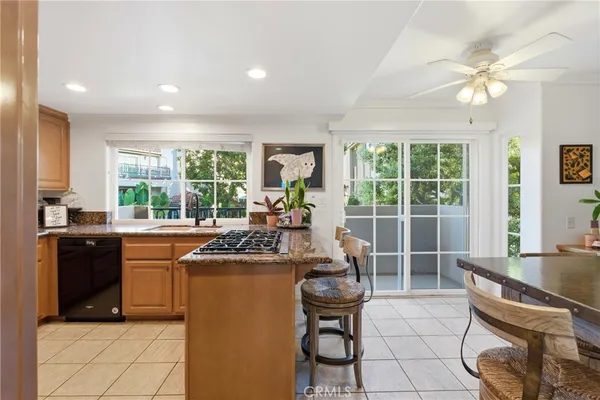 a kitchen with counter top space appliances and windows