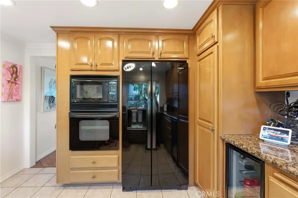 a kitchen with stainless steel appliances granite countertop a refrigerator and a stove