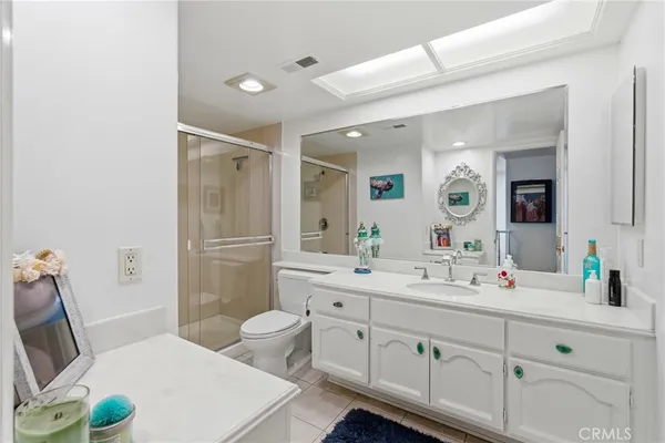 a spacious bathroom with a double vanity sink toilet and shower