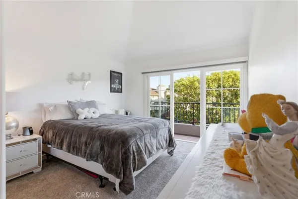 a bedroom with a bed couches and a large window