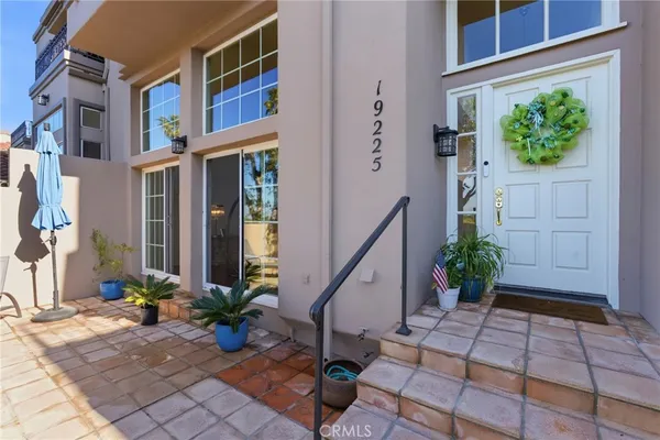 a view of a house with potted plants