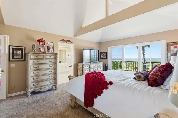 a bedroom with a bed and a television