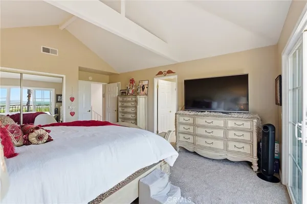 a bedroom with a bed and flat screen tv