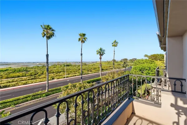 an aerial view of residential building with parking and city view
