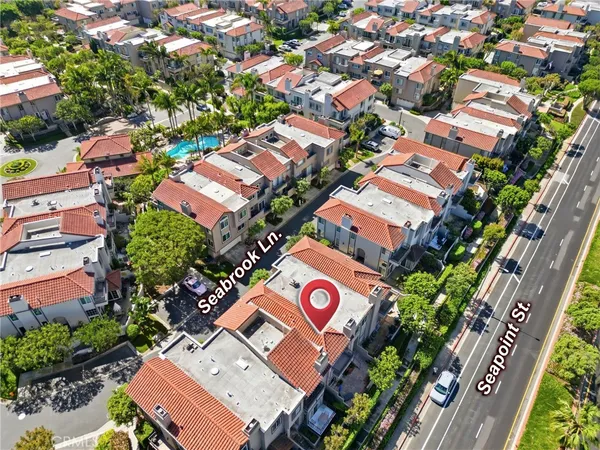 an aerial view of a house with a yard and garden