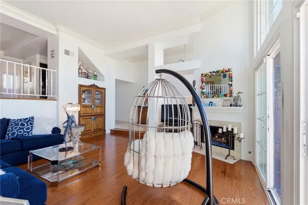 a view of entryway livingroom and hall with wooden floor