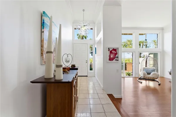a hallway with painting on the wall and a large mirror