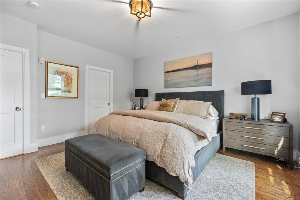 579 Baker Street, Unit 579 Boston, MA 02132 - Photo 14 of 30 a bedroom with bed and a couch