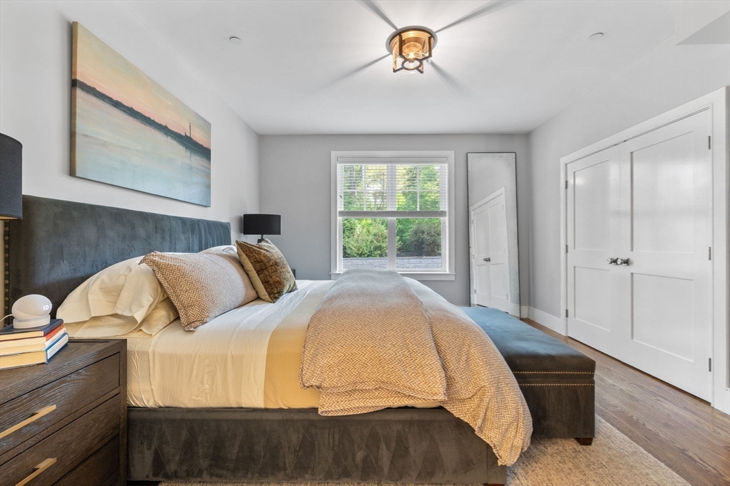 579 Baker Street, Unit 579 Boston, MA 02132 - Photo 15 of 30 a bed sitting in a bedroom next to a window