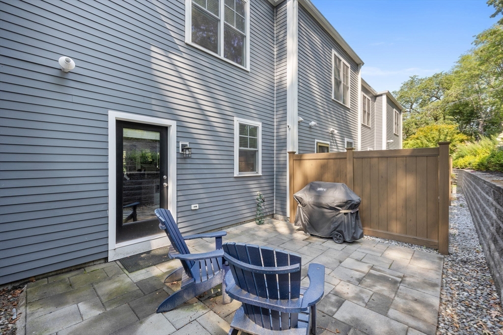 579 Baker Street, Unit 579 Boston, MA 02132 - Photo 25 of 30 a view of a patio with table and chairs and potted plants