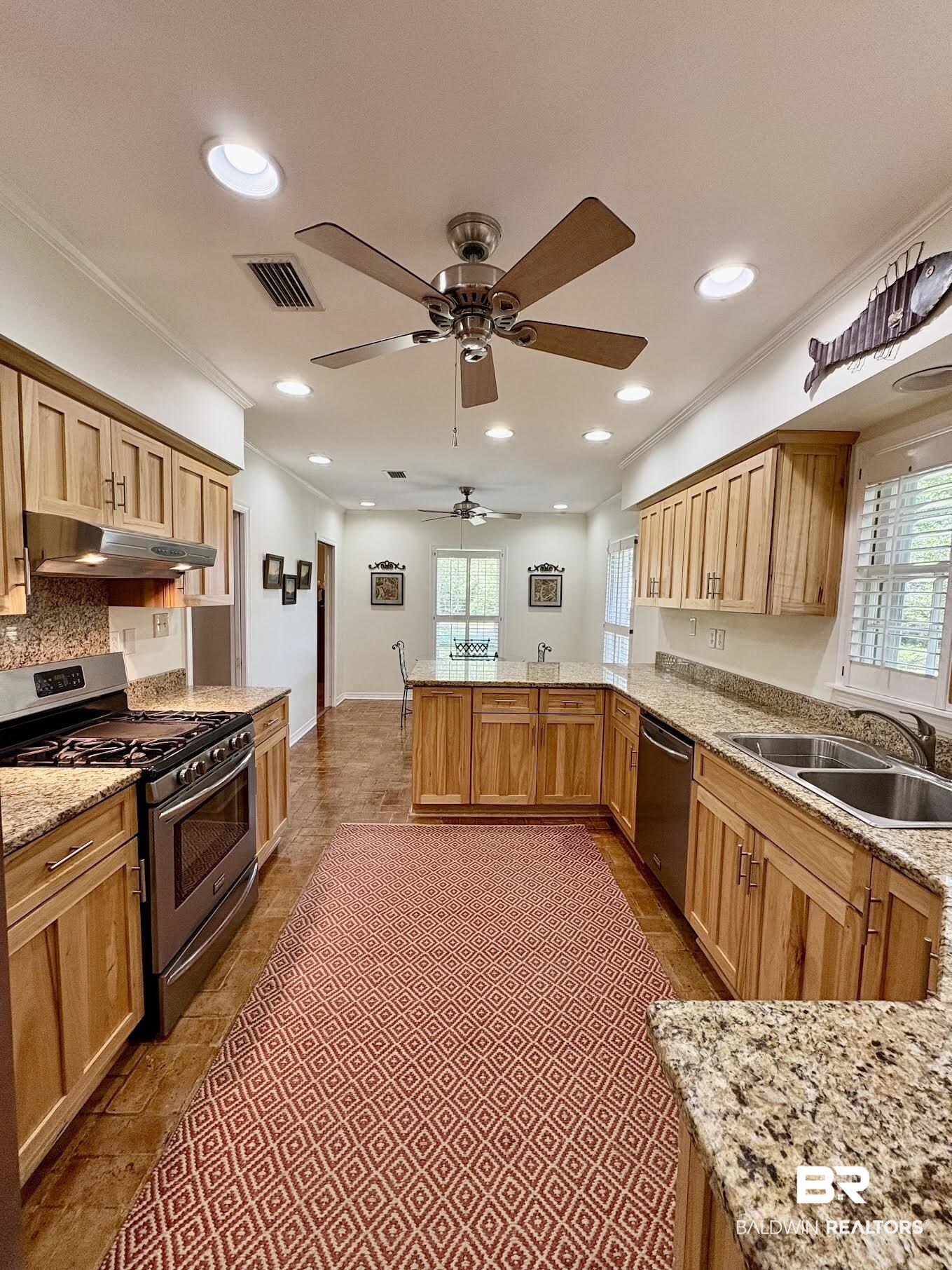 6105 Brandy Run Road South Mobile, AL 36608 - Photo 7 of 45 Kitchen with stainless steel appliances, under cabinet range hood, a sink, a peninsula, and ornamental molding