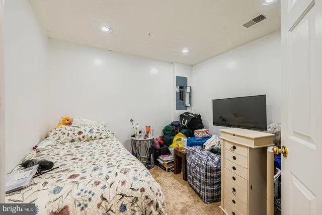 a bedroom with a bed and flat screen tv
