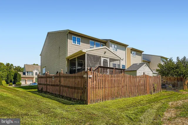 a view of a house with wooden fence