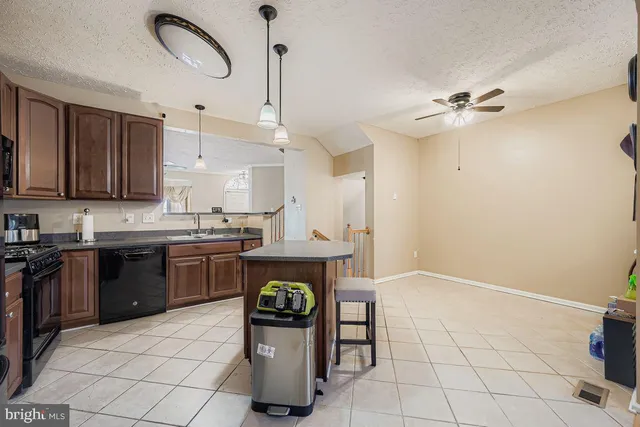 a kitchen with a sink appliances and cabinets