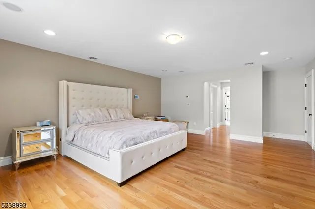 a bedroom with a bed and a night stand