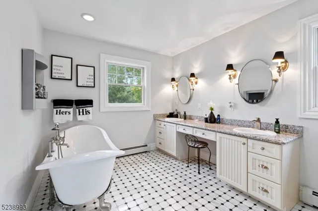 a bathroom with a bathtub sink and mirror