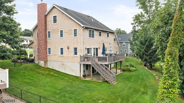a view of a house with a yard and deck