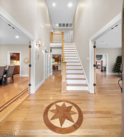 a view of a hallway with dining room and stairs
