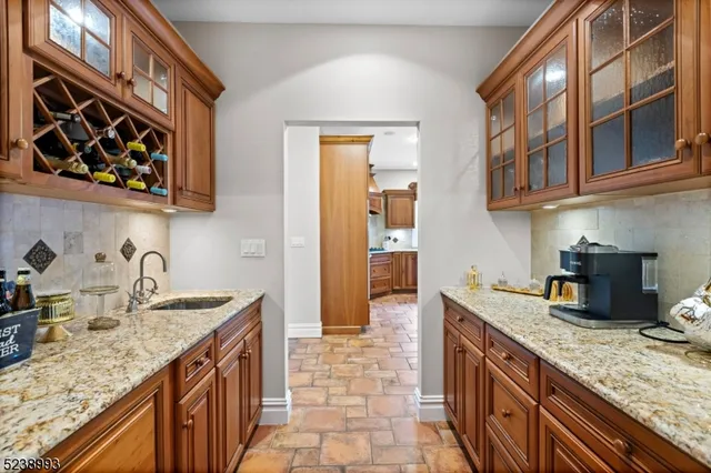 a kitchen with stainless steel appliances granite countertop a sink stove and cabinets