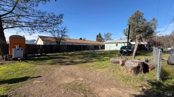 a view of a house with backyard and sitting area