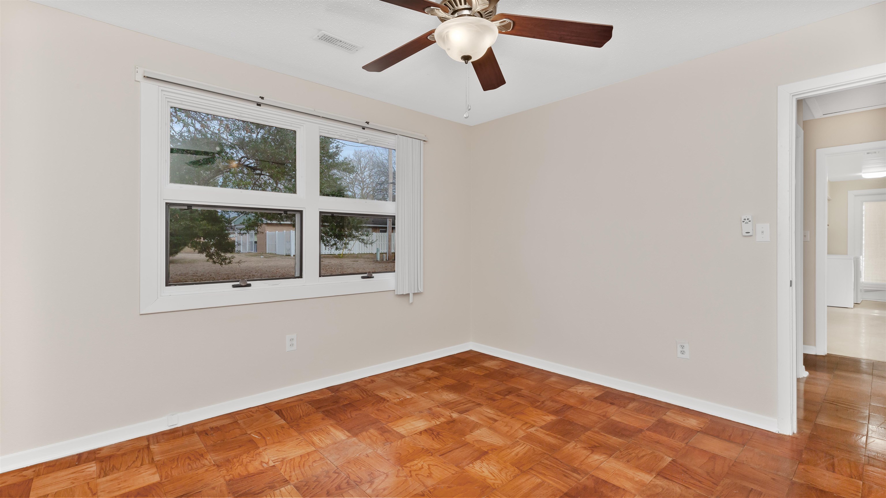 539 Redwood Avenue, Unit 539 Myrtle Beach, SC 29577 - Photo 19 of 42 Master bedroom featuring parquet flooring, ceiling fan and large window for natural light.