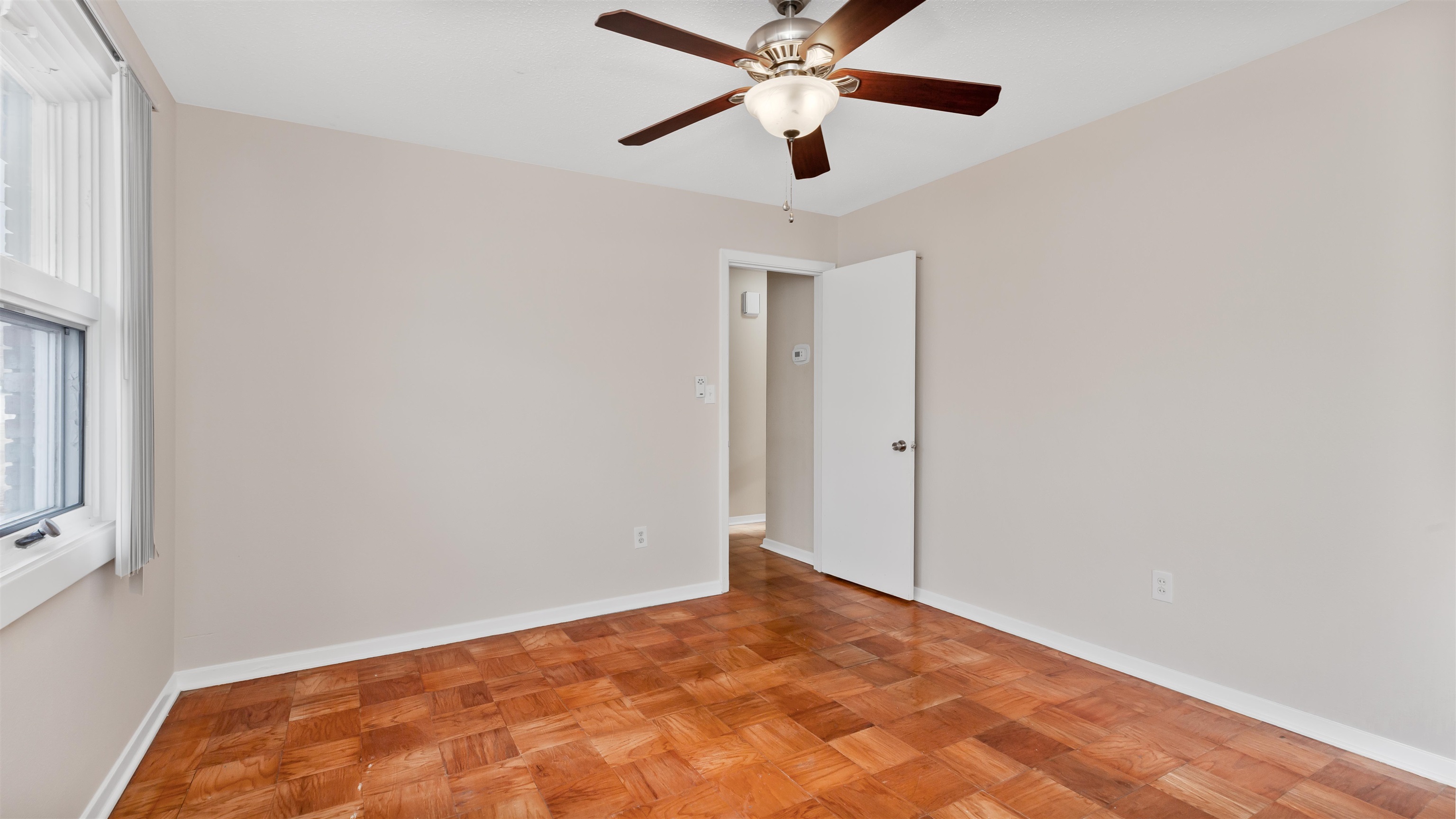 539 Redwood Avenue, Unit 539 Myrtle Beach, SC 29577 - Photo 21 of 42 Master bedroom featuring parquet flooring, ceiling fan and large window for natural light.