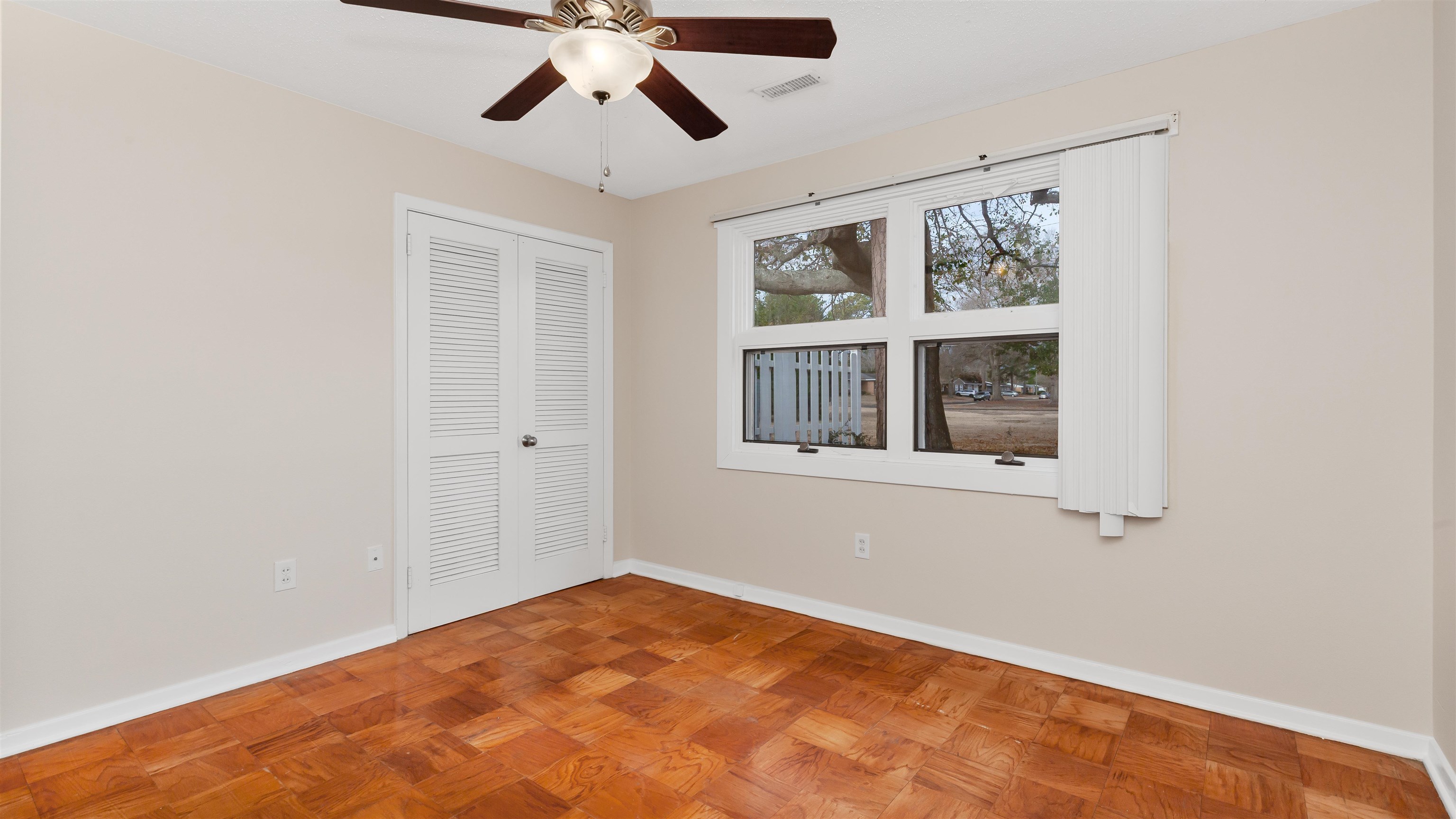 539 Redwood Avenue, Unit 539 Myrtle Beach, SC 29577 - Photo 22 of 42 Master bedroom featuring parquet flooring, ceiling fan and large window for natural light.