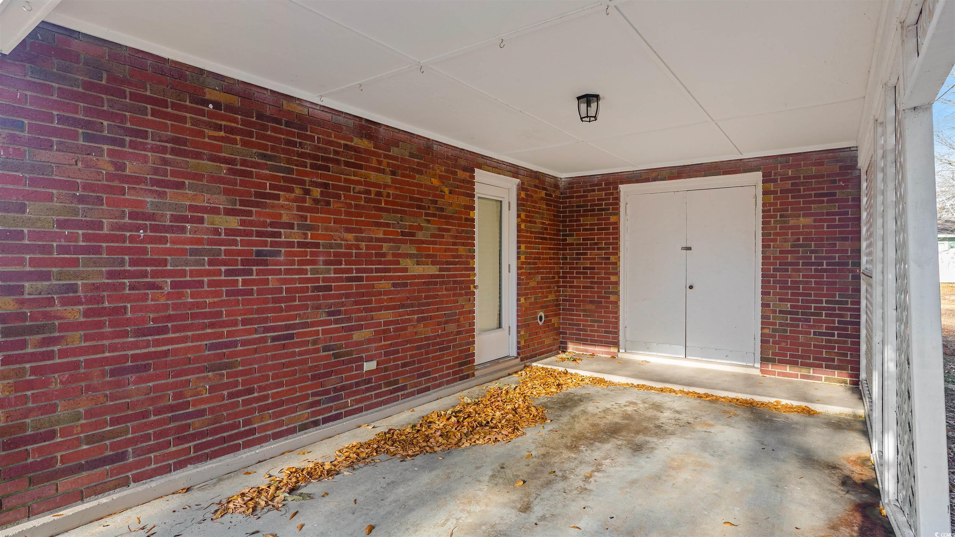 539 Redwood Avenue, Unit 539 Myrtle Beach, SC 29577 - Photo 27 of 42 Side entrance within carport including exterior storage closet