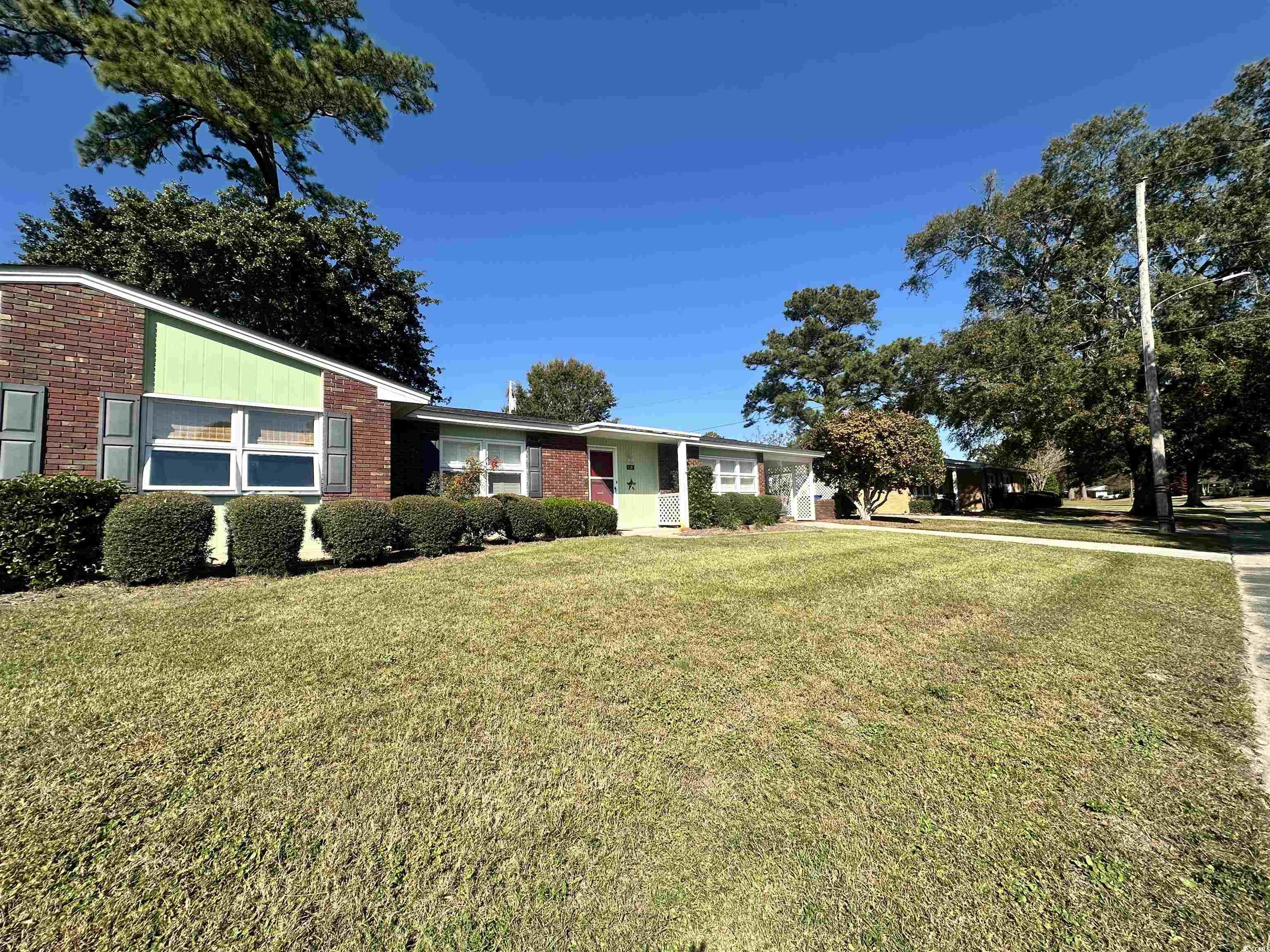 539 Redwood Avenue, Unit 539 Myrtle Beach, SC 29577 - Photo 4 of 23 View of front of house featuring a front yard and brick siding