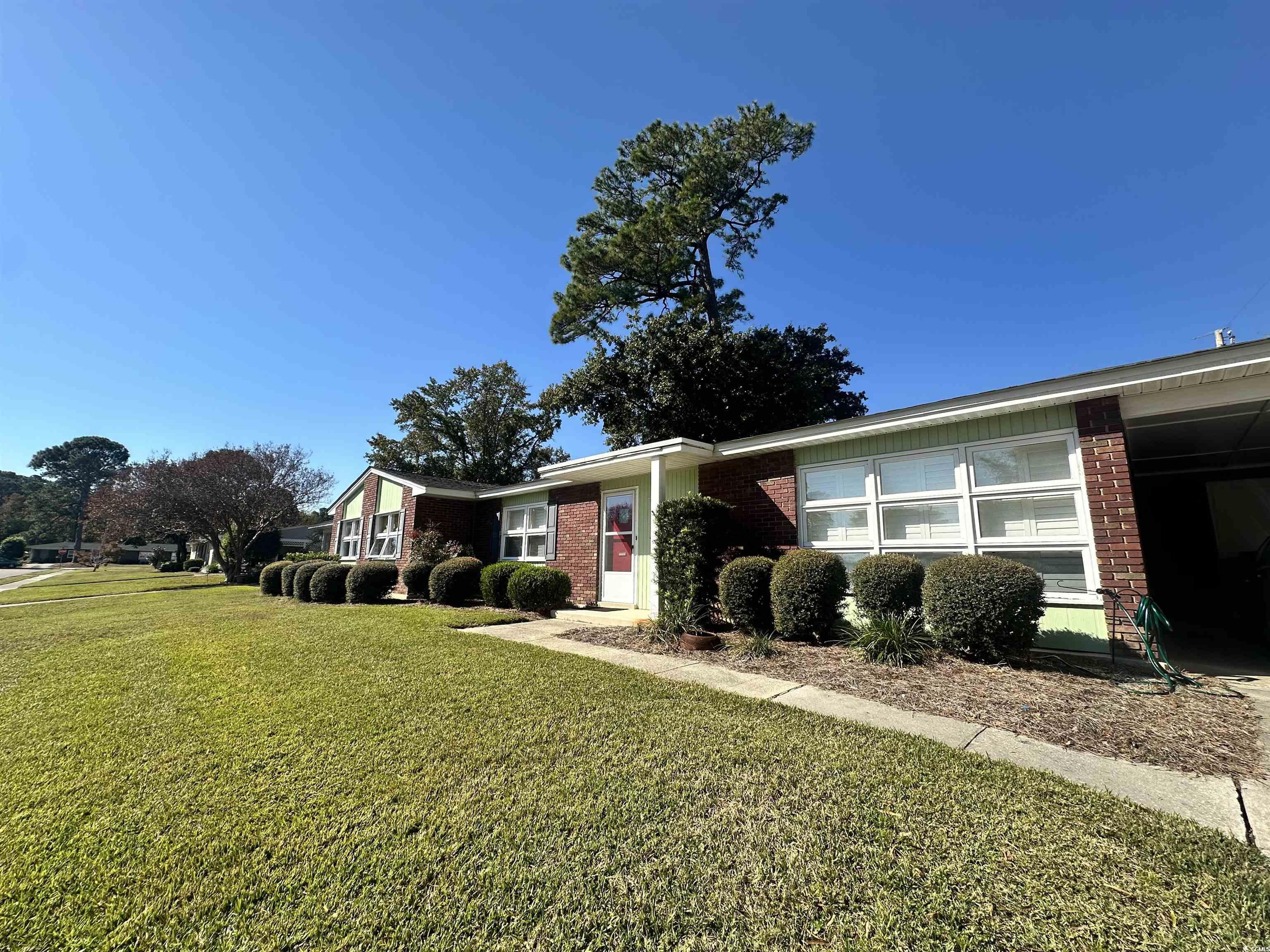 539 Redwood Avenue, Unit 539 Myrtle Beach, SC 29577 - Photo 5 of 23 View of front facade with a front yard and brick siding